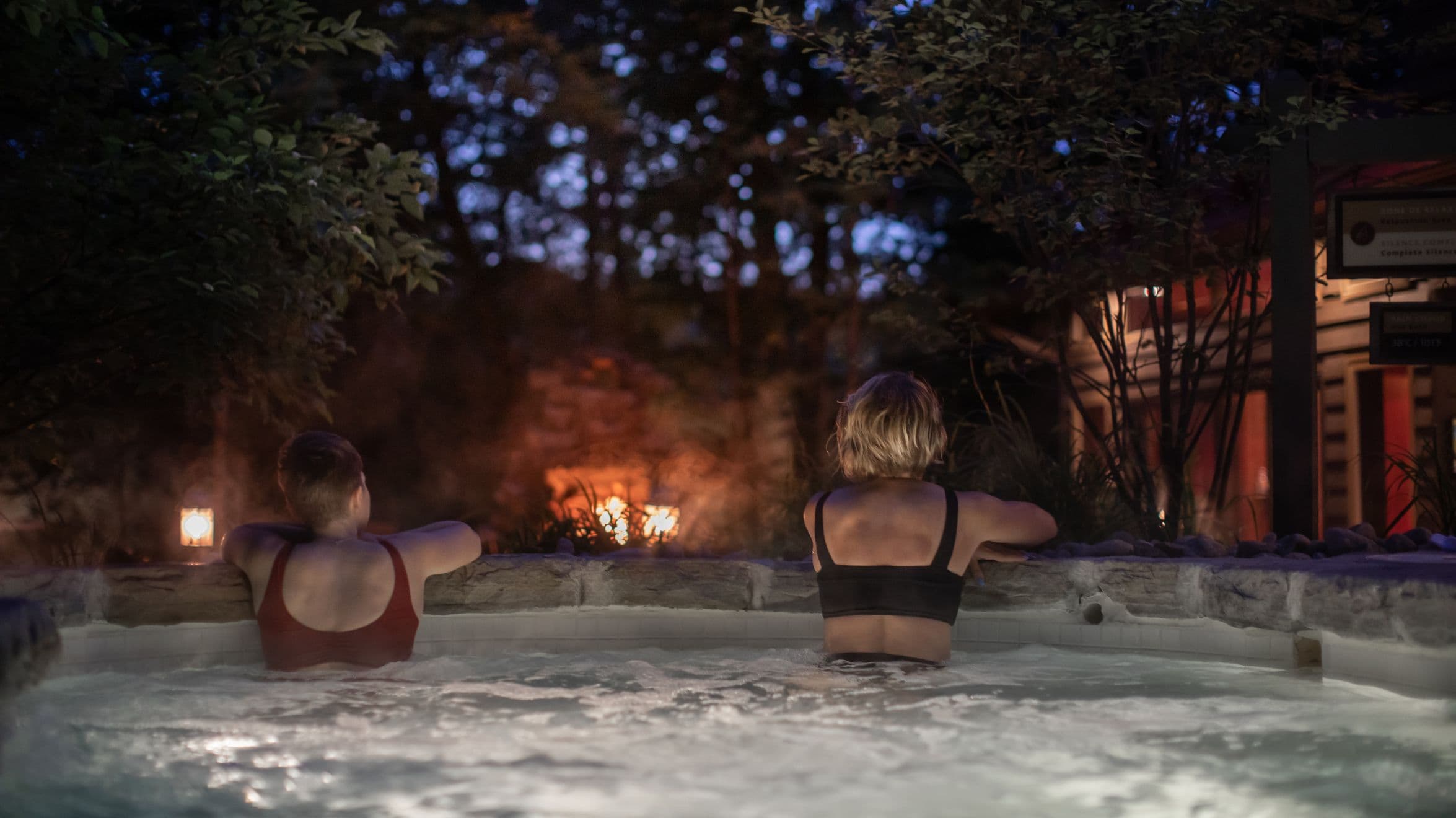 two people in hot tub at night time