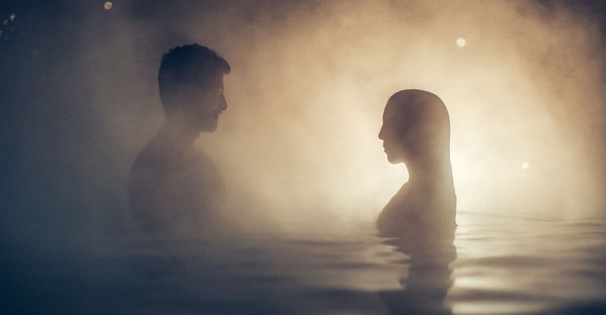 A couple relax in an outdoor hot tub at the Nordic spa, Scandinave Spa Mont-Tremblant.