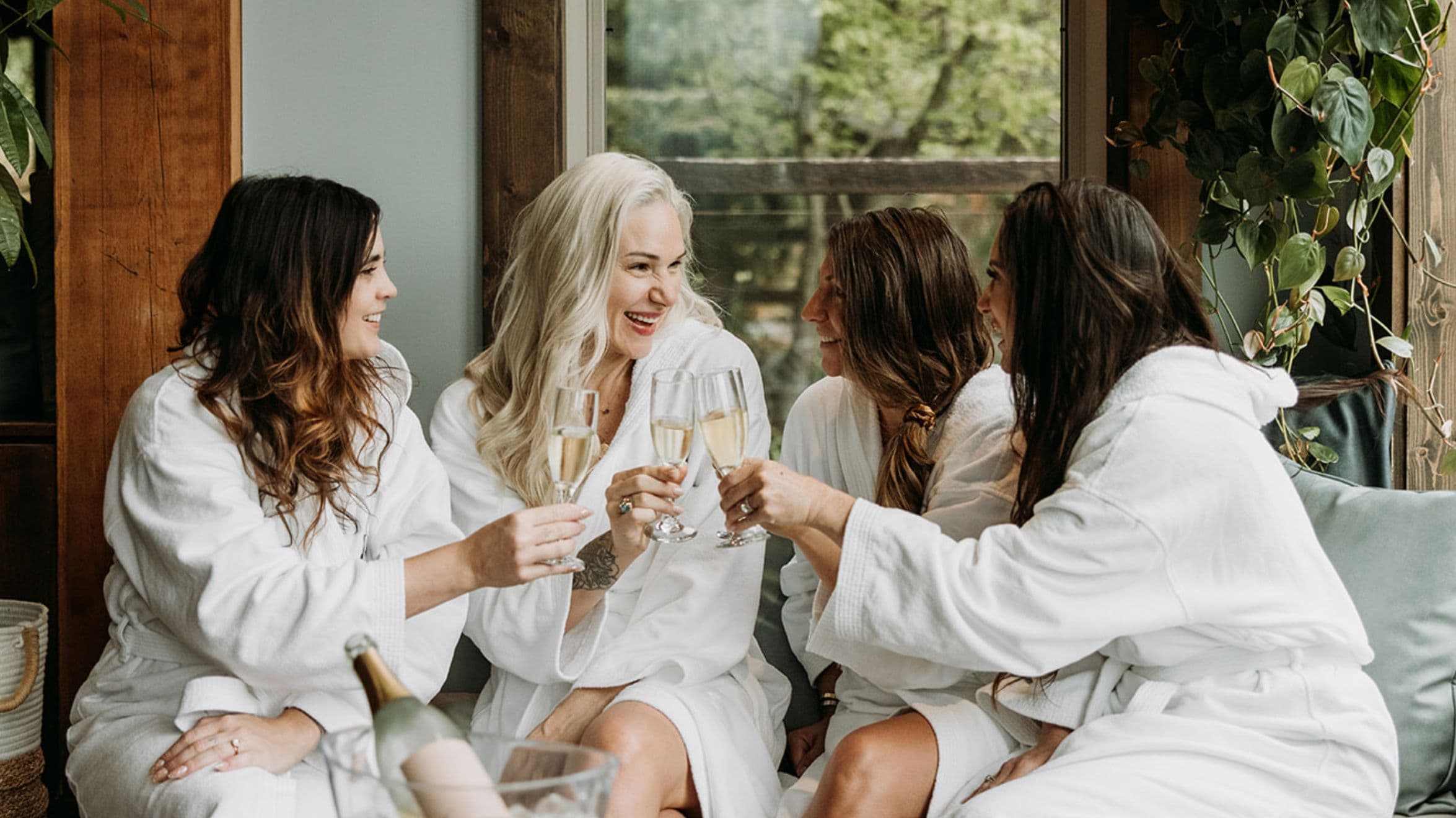 From L to R: Janet Helou, Marina Billinghurst and Jane Stoller cheers to celebrate with a glass of Glimmer sparking wine at Scandinave Spa Whistler's lounge
