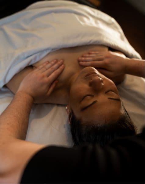 Guest enjoying a relaxing massage treatment on a massage table.