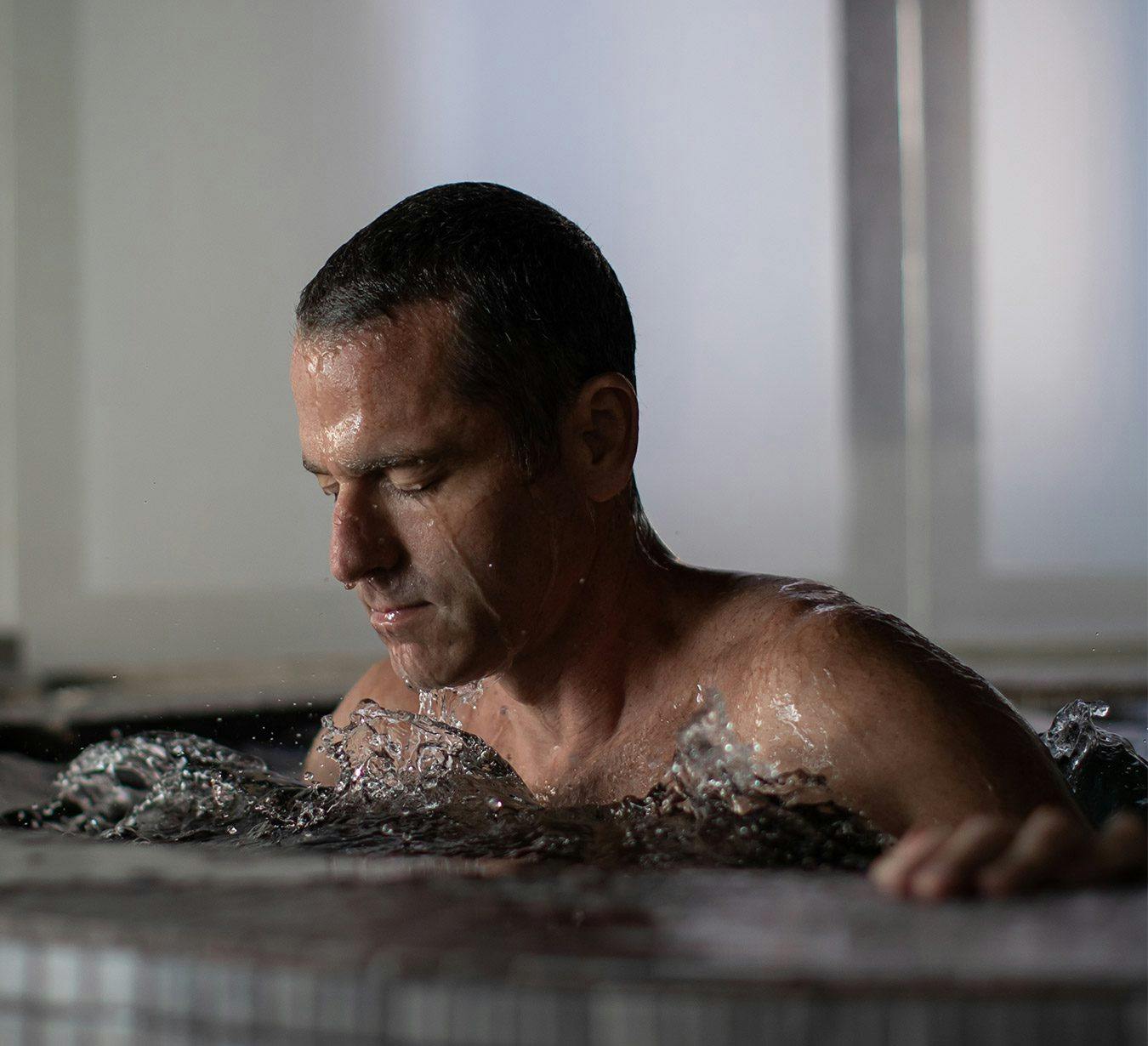 Scandinave spa hydrotherapy guide Scott Simons manages his breath and stays in the present moment when he immerses his entire body in the cold plunge pool.