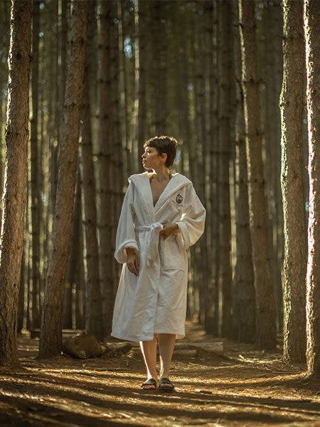 woman relaxing and enjoying forest bathing at Scandinave Spa