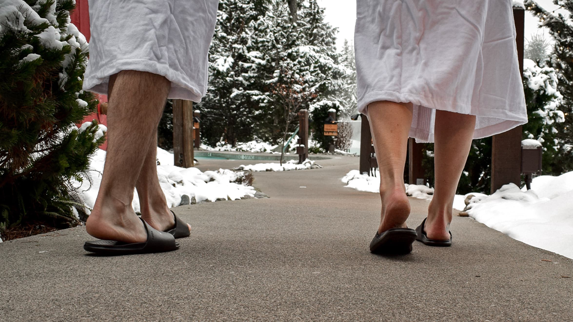 A couple on a short outdoor walk to refresh the mind and body at Scandinave Spa Whistler.