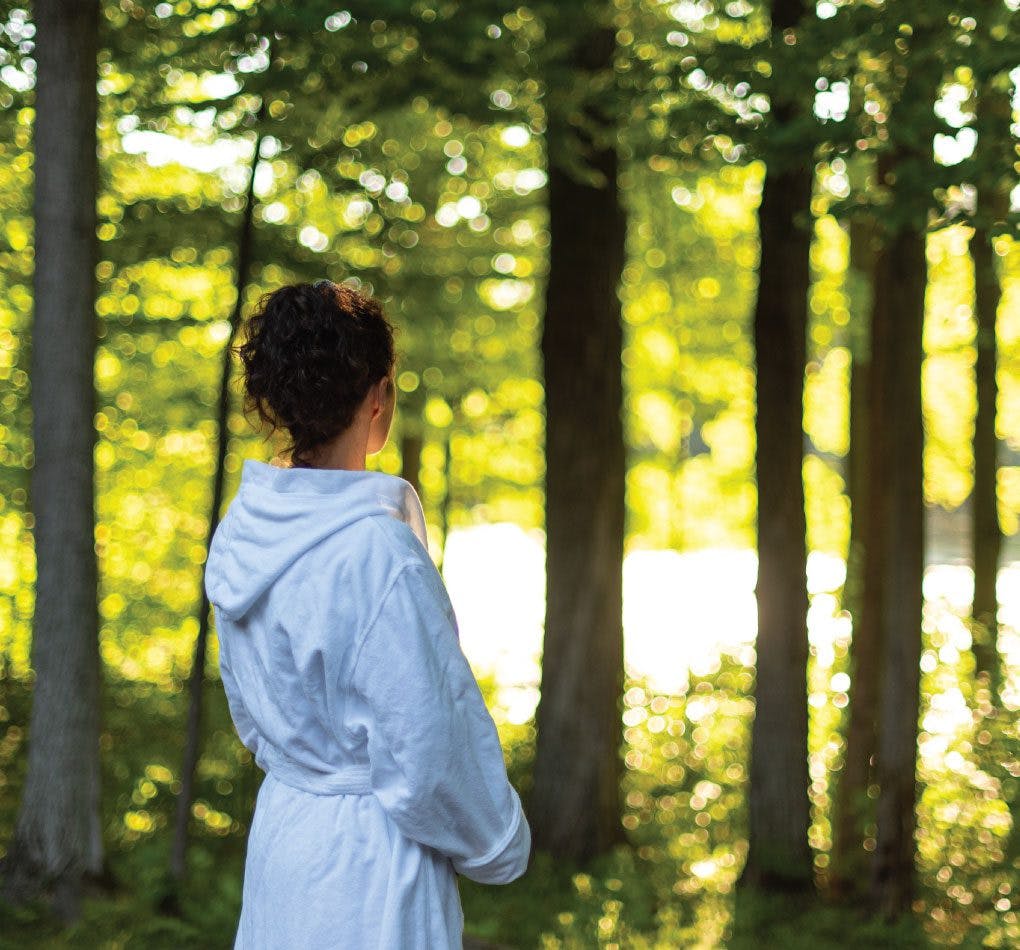 A woman Forest Bathing at Scandinave Spa Blue Mountain