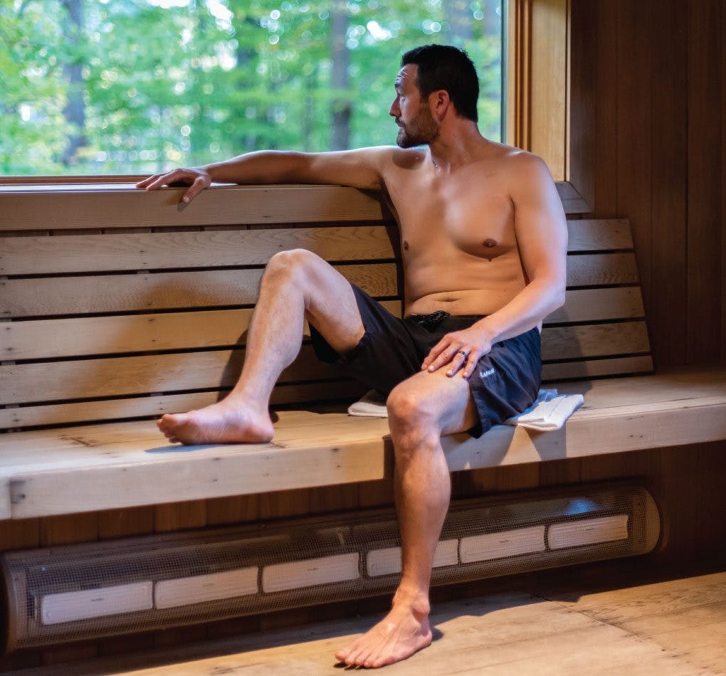 A man relaxing in the Sauna at Scandinave Spa Blue Mountain.