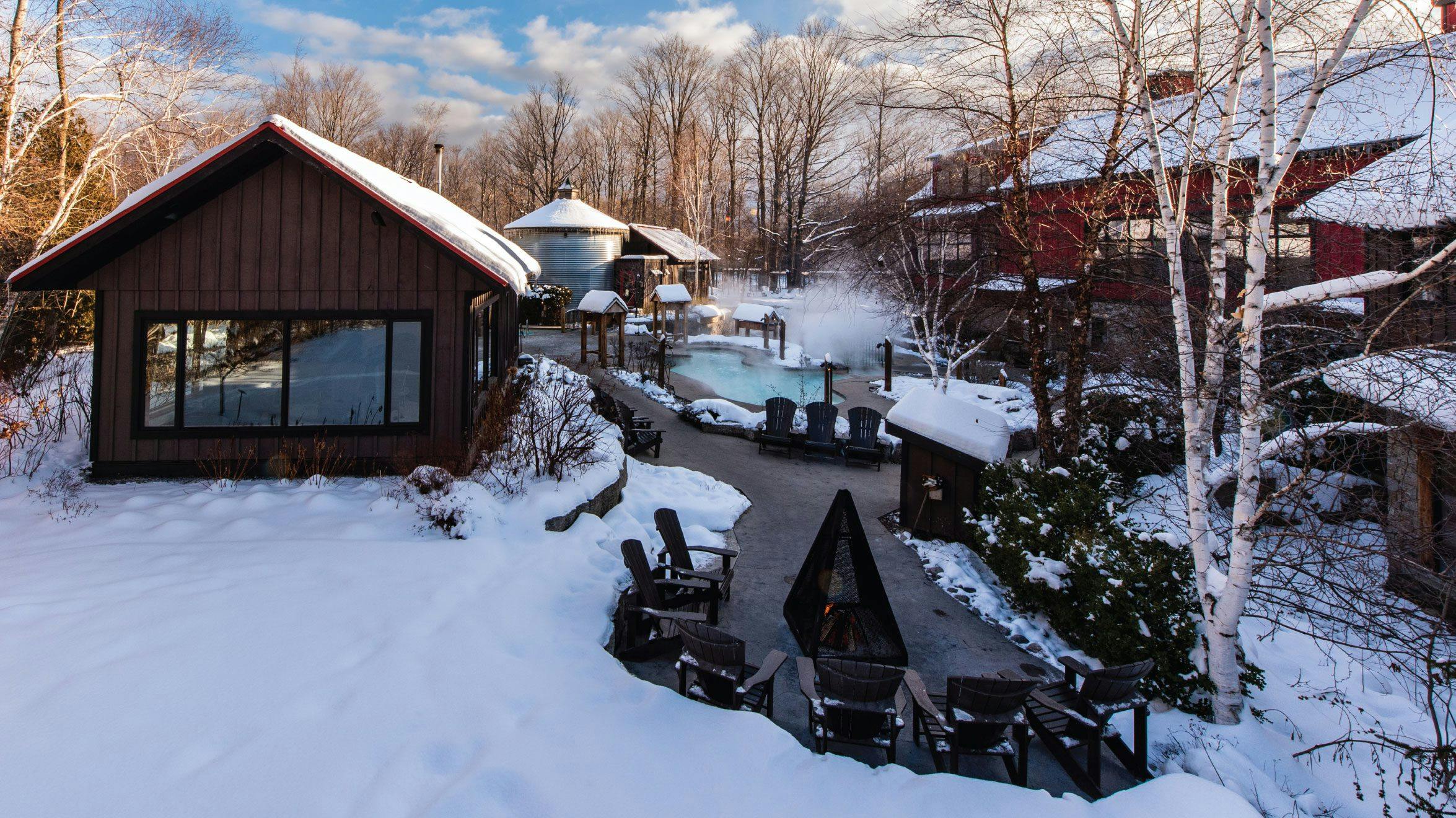 outdoor hot Bath and outdoor fireplace in winter at Scandinave Spa Blue Mountain.