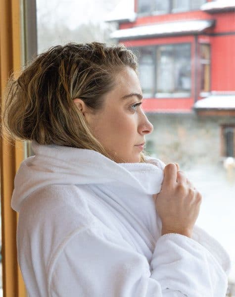woman looking out the window at Scandinave Spa Blue Mountain.