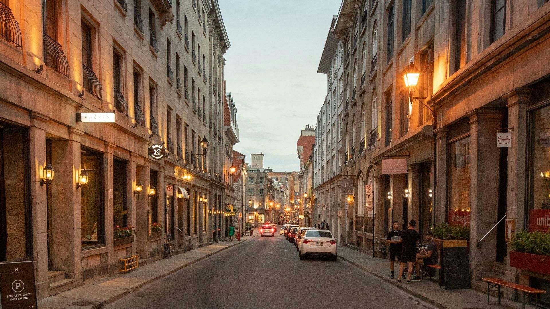 Old Montreal at sunset, grand stone buildings frame the historic street where Scandinave Spa is located.