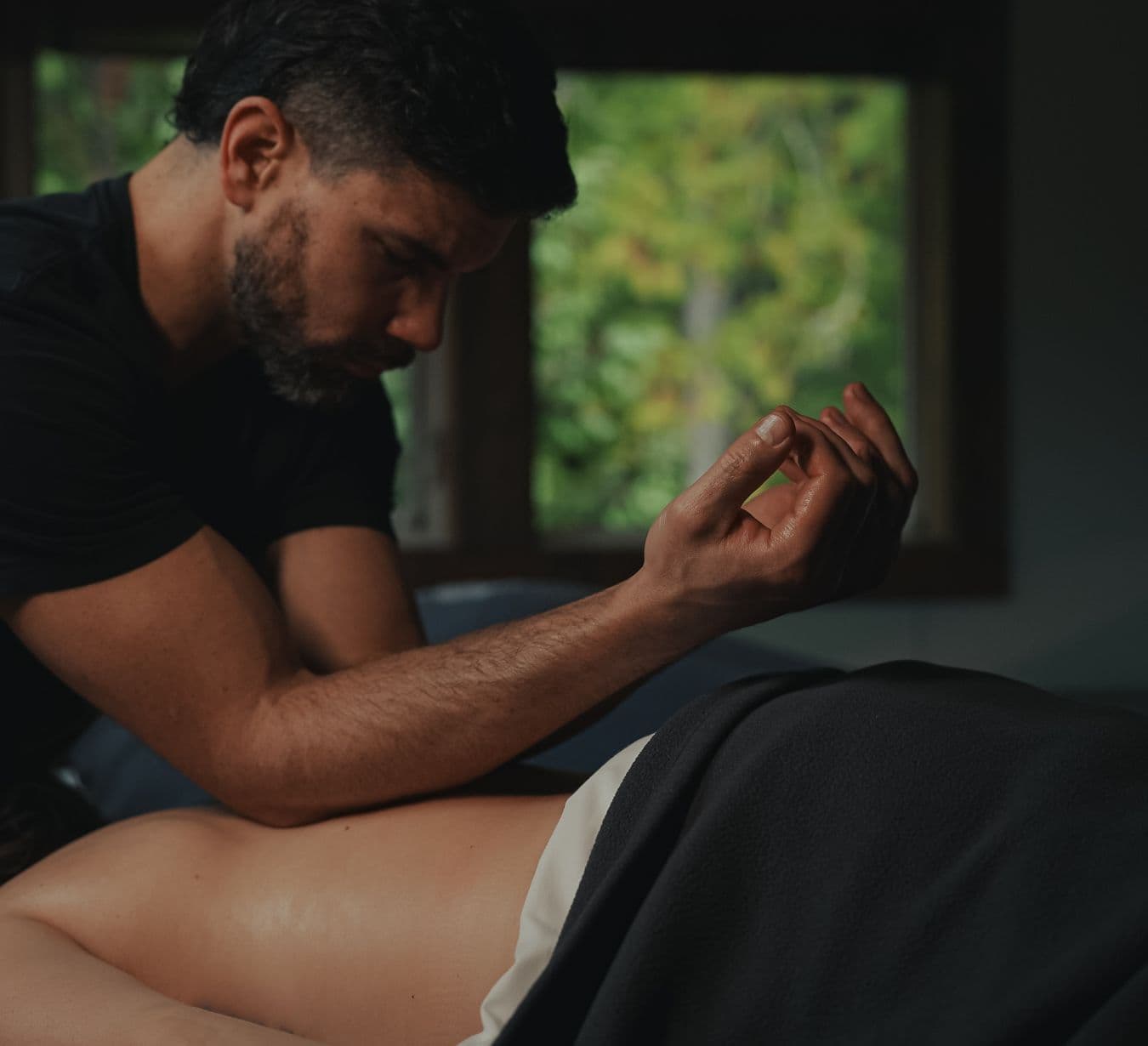 Male therapist gives guest a massage at Scandinave Spa Whistler